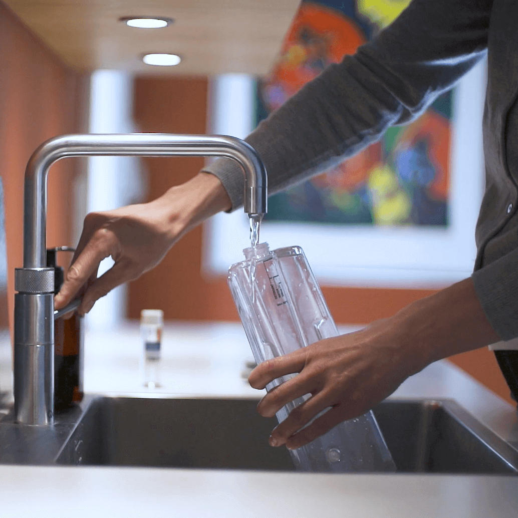 Filling floor washer cleaning tank with water