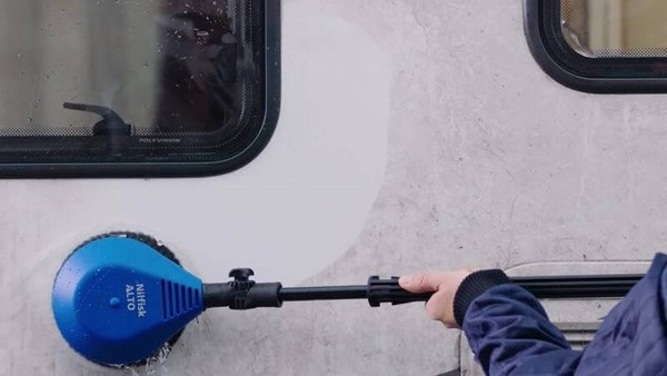 Cleaning car with high pressure washer and rotary brush accessory