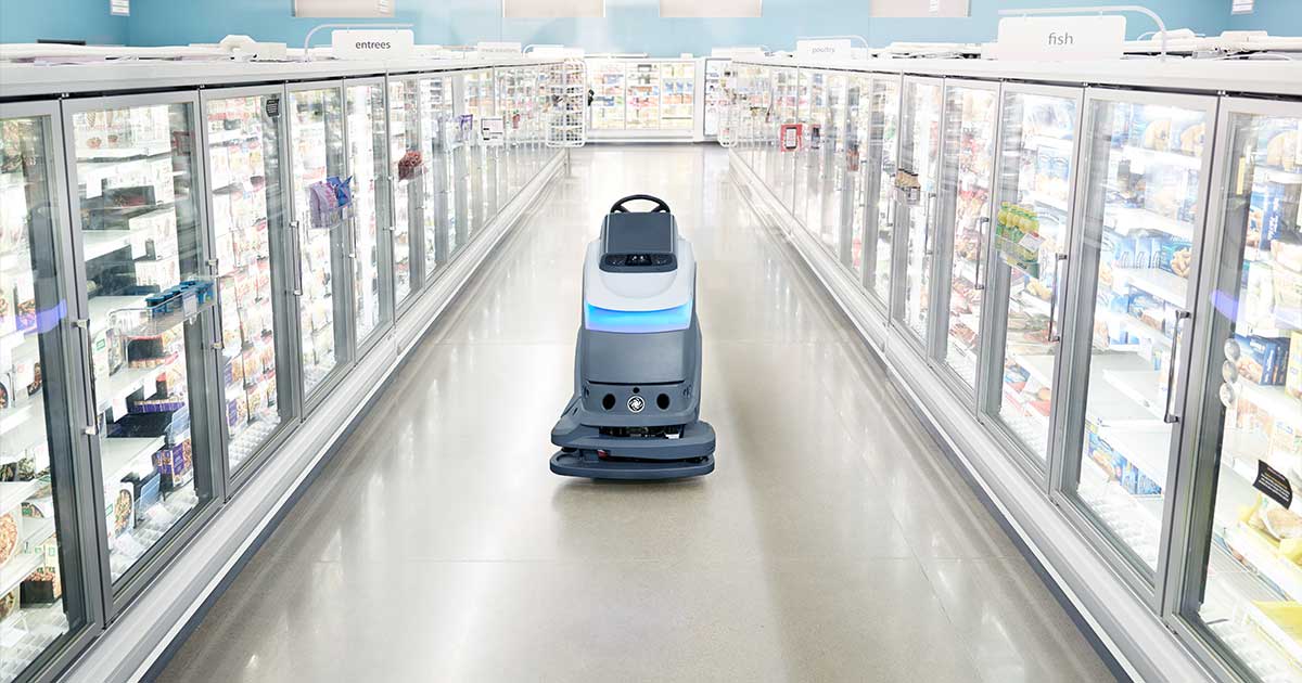 Robot cleaning machine in supermarket aisle