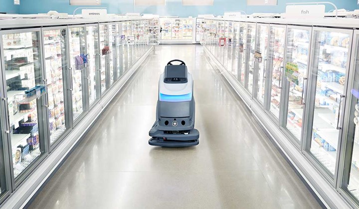 Robot cleaning machine in supermarket aisle